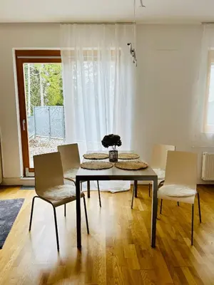 a dining room with a table and chairs and a window at Pohorske terase Gabi in Pohorje