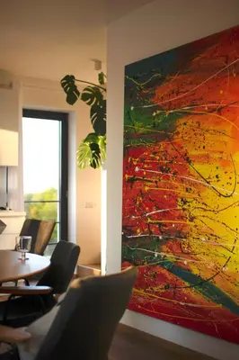 a large painting hanging on a wall in a room at Hiša ob stolpu in Lendava