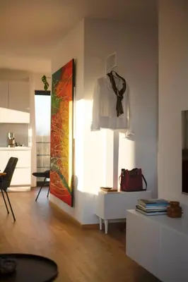 a living room with a shirt hanging on a wall at Hiša ob stolpu in Lendava
