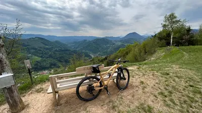 a bike is parked next to a bench at Brunarica Jeršin in Cerkno