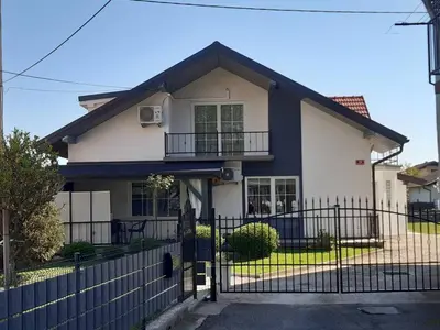 a white house with a black fence at Apartman Slivnica pri Mariboru in Slivnica pri Mariboru