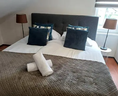 a large bed with two rolled towels on it at Apartman Slivnica pri Mariboru in Slivnica pri Mariboru