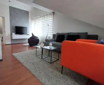 a living room with a couch and a table at Apartman Slivnica pri Mariboru in Slivnica pri Mariboru