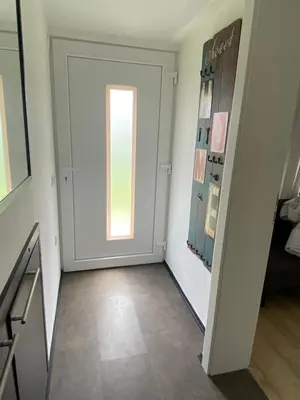 an empty hallway with a door and a window at Apartman Slivnica pri Mariboru in Slivnica pri Mariboru