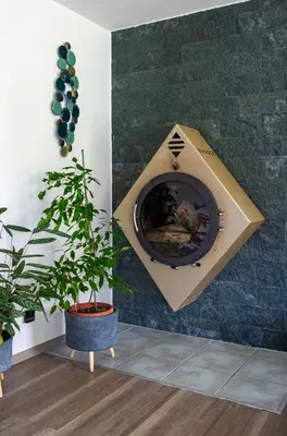 a fire place on a wall with two potted plants at Guest house TOMAN in Bled
