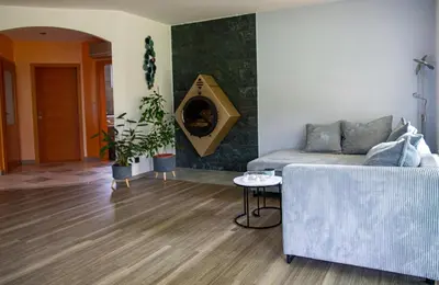 a living room with a couch and a fireplace at Guest house TOMAN in Bled
