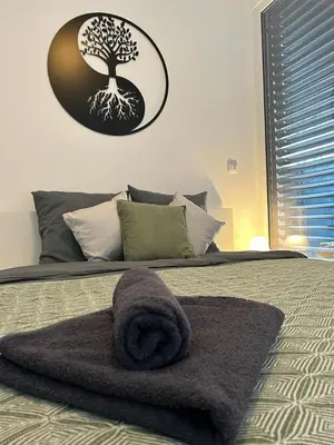 a bedroom with a bed with a towel on it at LA Studio in Maribor