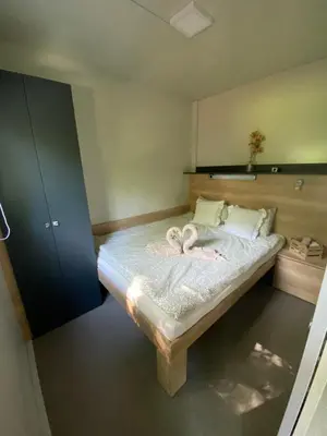 a bedroom with a bed with two hearts on it at Metkina Hiška -samooskrbna in Topovlje