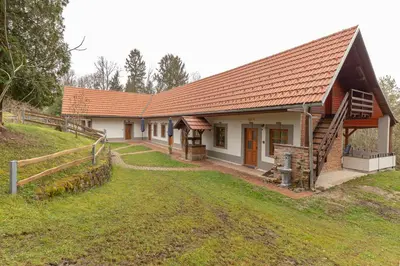 a house with a fence in front of it at Goričko Relax House in Kuzma
