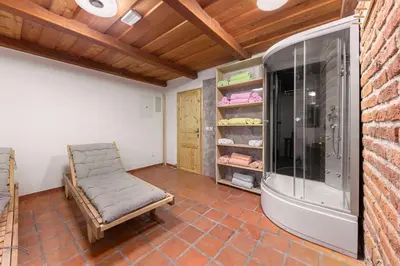 a room with a chair and a walk in closet at Goričko Relax House in Kuzma