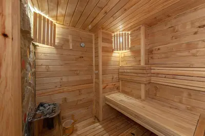 a wooden sauna with a bench inside of it at Goričko Relax House in Kuzma