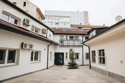 a christmas tree in a courtyard between two buildings at Apartment Center - Kersnikova in Ljubljana