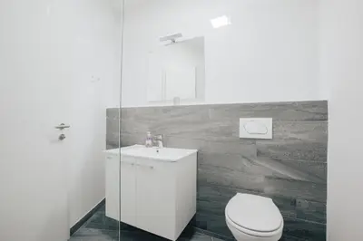 a bathroom with a white toilet and a sink at Apartment Center - Kersnikova in Ljubljana
