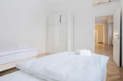 a white room with a large white bed in it at Apartment Center - Kersnikova in Ljubljana