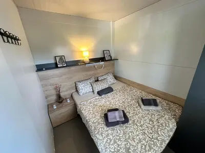 a small room with a bed and two pillows at BB HOUSE KOLPA RIVERSIDE in Metlika