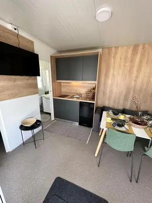 a kitchen with a table and chairs in a room at BB HOUSE KOLPA RIVERSIDE in Metlika