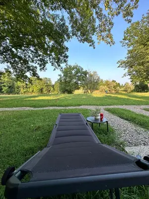 a black picnic table with a cup of coffee on it at BB HOUSE KOLPA RIVERSIDE in Metlika