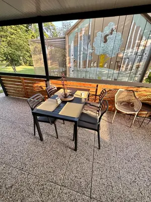 a table and chairs sitting on a patio at BB HOUSE KOLPA RIVERSIDE in Metlika