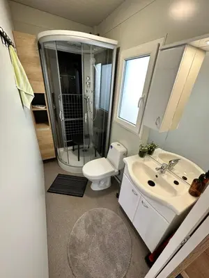 a bathroom with a shower and a toilet and a sink at BB HOUSE KOLPA RIVERSIDE in Metlika