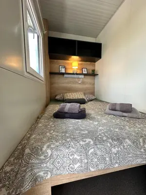 a bedroom with a large bed in a room at BB HOUSE KOLPA RIVERSIDE in Metlika