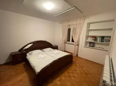 a bedroom with a bed with two towels on it at Hiša Pod Slavnikom in Podgorje