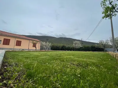 a large yard with green grass and a house at Hiša Pod Slavnikom in Podgorje