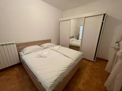 a bedroom with a bed with two white towels on it at Hiša Pod Slavnikom in Podgorje