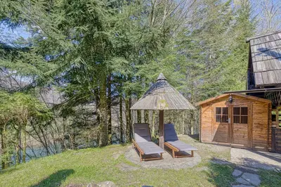 a couple of lounge chairs and a gazebo at Fani's Riverside Cottage - Happy Rentals in Kostel