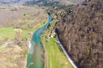 an aerial view of a river next to a forest at Fani's Riverside Cottage - Happy Rentals in Kostel