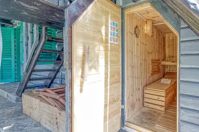 a wooden house under construction with a ladder at Fani's Riverside Cottage - Happy Rentals in Kostel