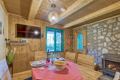 a dining room with a table and a fireplace at Fani's Riverside Cottage - Happy Rentals in Kostel