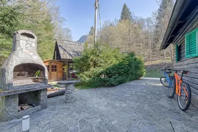a stone patio with a pizza oven in front of a house at Fani's Riverside Cottage - Happy Rentals in Kostel