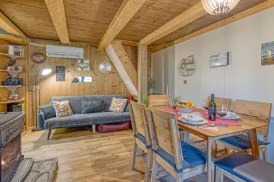 a living room with a table and a couch at Fani's Riverside Cottage - Happy Rentals in Kostel
