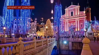 a city lit up with christmas lights and christmas trees at i Design 9 in Ljubljana