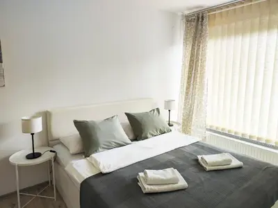 a bedroom with a bed with two towels on it at Petra Garden apartment in Bled