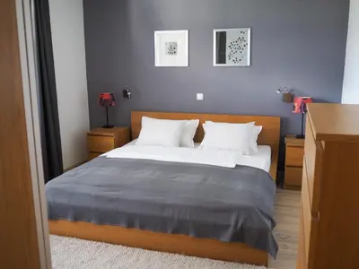 a bedroom with a bed and two night stands at Petra Garden apartment in Bled