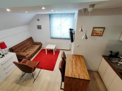 a living room with a couch and a table at Petra Garden apartment in Bled
