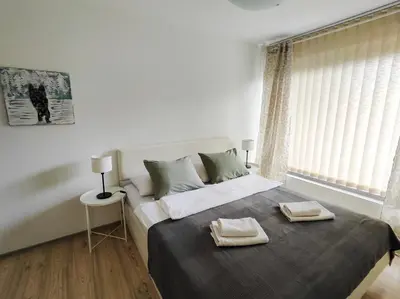 a bedroom with a bed with two towels on it at Petra Garden apartment in Bled