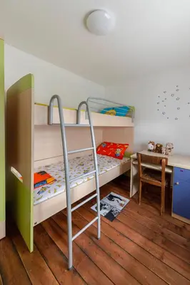 a bedroom with two bunk beds and a desk at Počitniška Hiša Pr Martinovih in Postojna