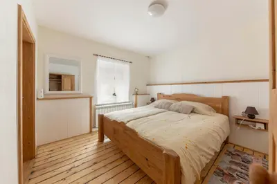 a bedroom with a large bed in a room at Počitniška Hiša Pr Martinovih in Postojna