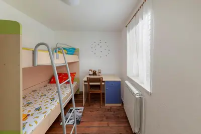 a small bedroom with bunk beds and a desk at Počitniška Hiša Pr Martinovih in Postojna