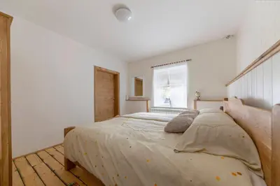 a bedroom with a bed and a window at Počitniška Hiša Pr Martinovih in Postojna
