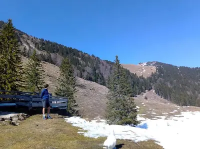 a person standing on top of a snow covered mountain at A Cottage in the Alps for hiking, cycling, skiing in Jesenice