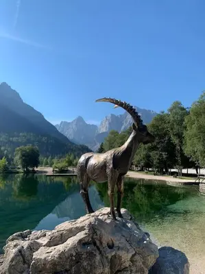 a statue of a ram standing on a rock at A Cottage in the Alps for hiking, cycling, skiing in Jesenice