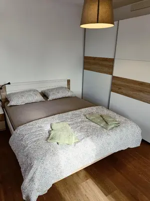 a bedroom with two beds and a lamp at Green Apartment Cerknica in Cerknica