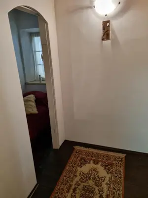 a hallway with a rug and a light on a wall at Blacksmith in Kropa