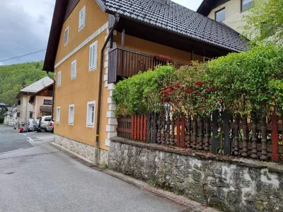 a building with a fence next to a street at Blacksmith in Kropa