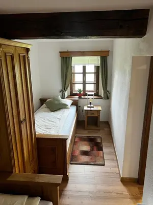 a small bedroom with a bed and a window at Boutique Farm Hrovat in Frankolovo