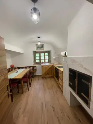 a kitchen with a table and a dining room at Boutique Farm Hrovat in Frankolovo
