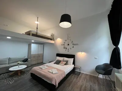 a bedroom with a large bed and a couch at Absolutum Apartments in Ljubljana